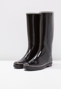 Bottes de pluie en caoutchouc noir à finition brillante, design haut jusqu'aux genoux, bordure blanche en haut et semelles texturées pour une meilleure adhérence.