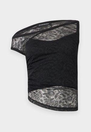 Haut en dentelle noir à une épaule avec motif floral et détails en mesh transparent, plié à plat sur un fond blanc.