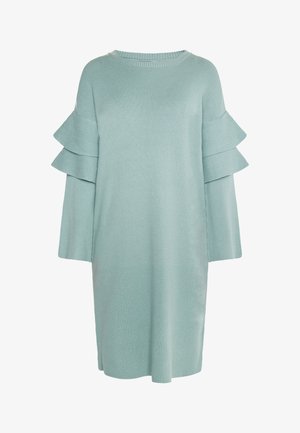 Šviesiai mėtų žalios spalvos megztinis suknelė, pagaminta iš raukšlėto audinio. Suknelė turi sluoksniuotus volanų akcentus ant rankovių ir laisvą, tiesią siluetą.