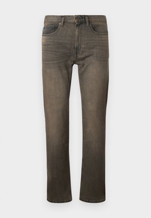 Falmede brune denim jeans med rette ben, bælteløkker, fem lommer og lynlås i front. Stoffet har en myk tekstur med subtile slitasjer.