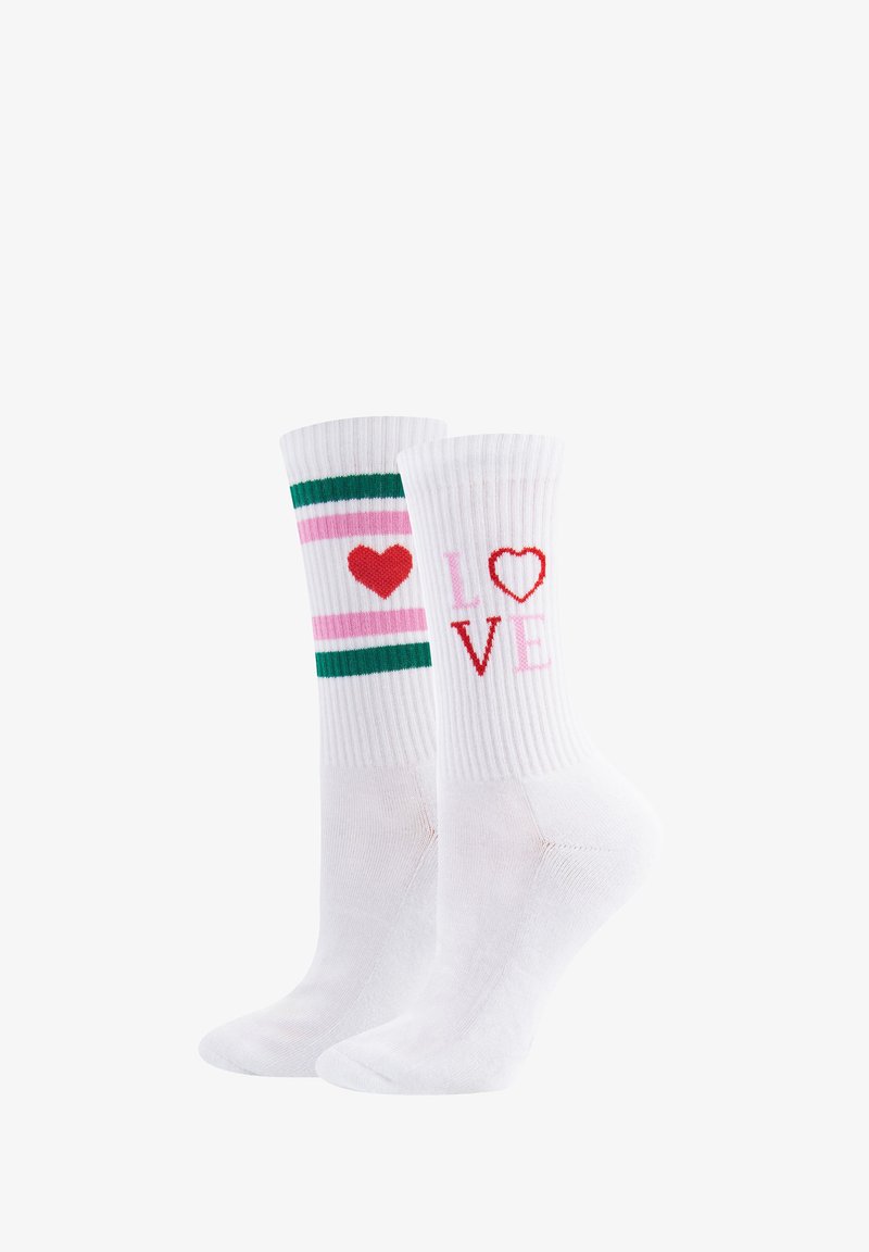 Chaussettes blanches jusqu'à la cheville avec une texture côtelée. Une chaussette arbore des rayures vertes et roses avec un cœur rouge, tandis que l'autre affiche le mot "LOVE" en lettres rouges et roses.