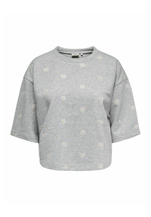 Sweat-shirt gris à manches courtes avec de petites impressions de marguerites blanches et jaunes dispersées sur le devant et les manches.