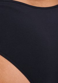 Navy blue swimsuit featuring a smooth, stretchy fabric with a rounded neckline and wide arm openings for enhanced comfort.