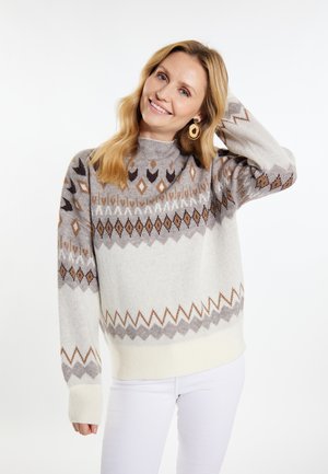 Gebreide sweater in lichtgrijs en crème met geometrische patronen in bruin en donkerder grijs. Heeft een hoge hals en geribde boorden.