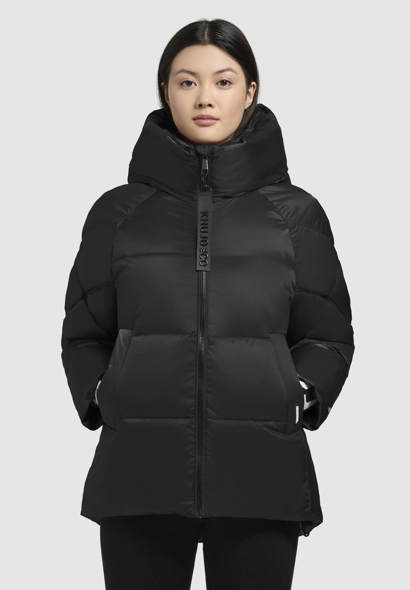 Black puffer jacket with a high collar, zip closure, and side pockets. Features quilted design and textured fabric.