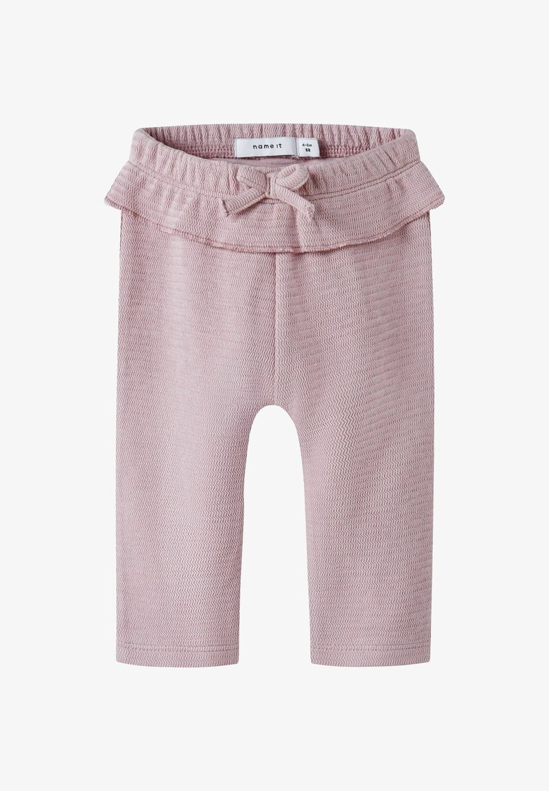 Lichtroze gebreide legging met een gestructureerd zigzagpatroon, elastische tailleband en een ruches met een strikdetail aan de bovenkant.