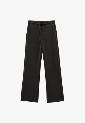 Pantalones de pierna ancha negros, hechos de una tela suave, con una cinturilla elástica con cordón y bolsillos laterales. Textura suave en toda la prenda.