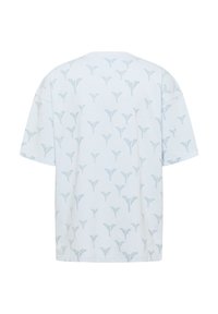 Ανοιχτό μπλε μπλουζάκι με επαναλαμβανόμενο μοτίβο φύλλων. Κοντά μανίκια, άνετη γραμμή, απαλό βαμβακερό ύφασμα και στρογγυλή λαιμόκοψη.