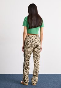 adidas Originals LEOPARD - Treniņtērpa apakšdaļas - black