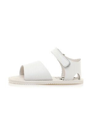 Sandali bianchi in pelle con punta aperta, ampie cinghie superiori e cinturino alla caviglia regolabile. Suola texturizzata per una buona aderenza e comfort.