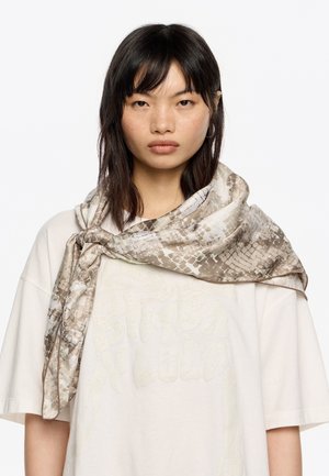Bufanda ligera con un diseño estampado en tonos beige y crema, con una textura de piel de serpiente, drapeada de forma elegante alrededor del cuello.