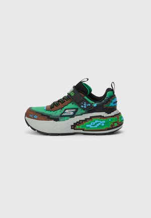 Green, brown, and black sneaker with pixelated design, thick white sole, mesh upper, and adjustable strap on the midfoot for secure fit.