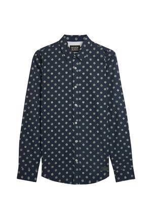 Camicia blu navy a maniche lunghe con bottoni, con motivi bianchi di sole e cerchi e una piccola etichetta del marchio vicino all'orlo.