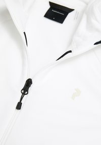 Giacca bianca con una texture liscia, dotata di una zip nera e un piccolo logo chiaro sulla parte frontale. Progettata con un taglio moderno.