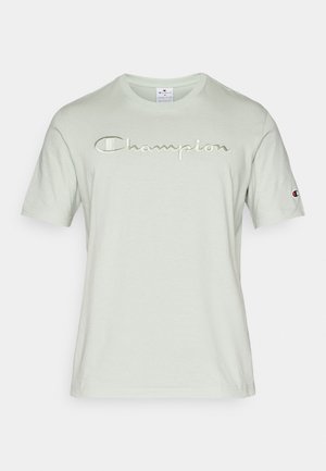 Mint green T-shirt in soft cotton, featuring an embroidered "Champion" logo in a slightly darker shade, short sleeves, and a round neckline.