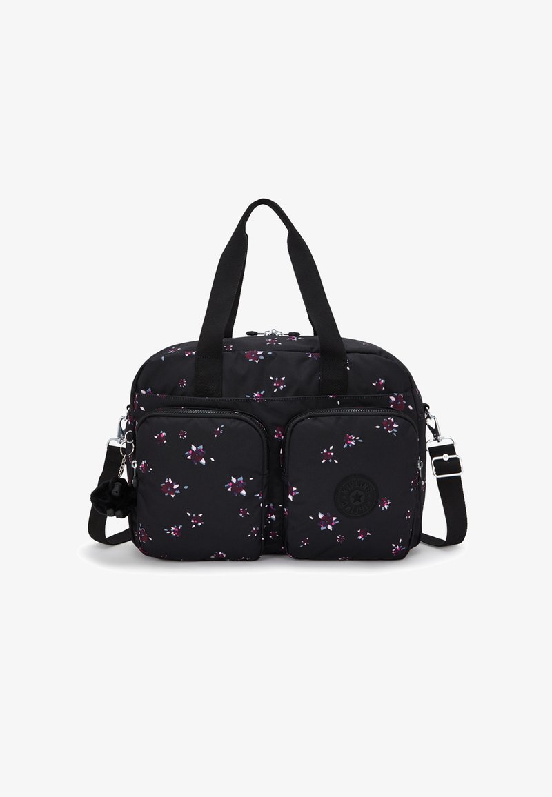 Svart tygväska prydd med ett blommönster i lila och vitt, med två framfickor, dubbelhandtag och en avtagbar axelrem.