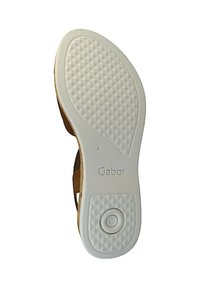 Tan sandal sole with textured white rubber, featuring diamond patterns and a circular detail. Brand name "Gabor" printed on the sole.