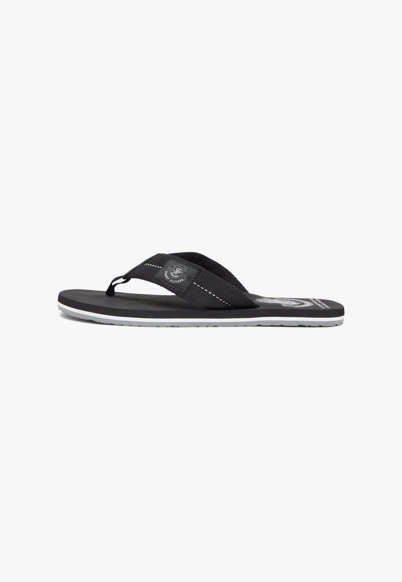 Black flip-flop sandal with textured fabric straps, rubber sole, and white accents. Features logo detail on the strap.