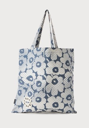 Sac cabas bleu et blanc avec un grand motif floral stylisé à pois et deux poignées pour le porter à la main ou à l'épaule.
