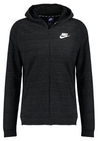 Svart zip-up hoodie i texturerat tyg, med en frontdragkedja, långa ärmar och en vit Nike-logotyp på vänster bröst.