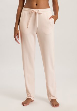 Lichtroze sweatpants met een trekkoord in de taille, zijzakken en een gladde, zachte stof. Relaxte pasvorm die naar de enkel toe tapert.