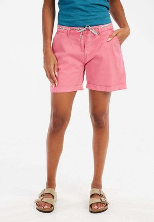 Pink cotton shorts with a folded hem, featuring a patterned waistband and a drawstring. Paired with beige sandals.