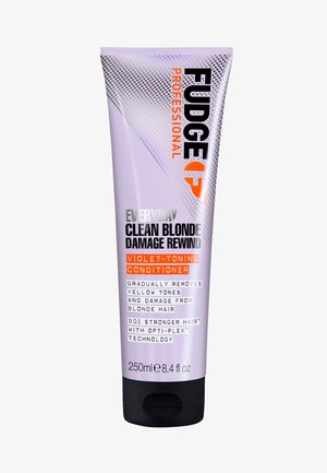 Après-shampoing tonifiant violet dans un tube de 250 ml. Présente une finition lavande, un texte noir et orange audacieux, et un capuchon noir. Contient la technologie OPTI-PLEX.