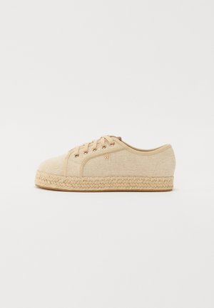 Beige canvas shoes with a round toe, jute rope sole, and five eyelets for laces. Features a small embossed logo on the side.