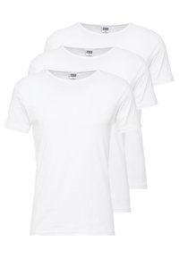 Trois T-shirts blancs à manches courtes disposés en pile. Fabriqués en coton, ils ont un col rond et une coupe régulière.