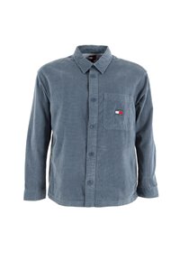 Camisa de manga larga de corduroy azul con cuello abotonado, bolsillo frontal y parche de logo. Tejido texturizado con un sutil diseño acanalado.