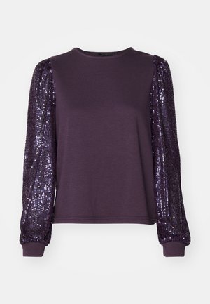 Vijolična dolga majica z dolgimi rokavi iz mehkega materiala in bleščečimi puf rukavi, z okroglim izrezom in prilegajočimi manšetami.