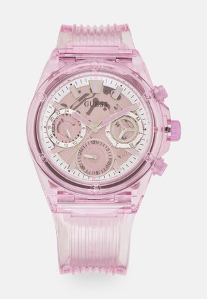 Transparente rosa Uhr mit rundem Gehäuse, weißem Zifferblatt, drei Unterzifferblättern und einem strukturierten Silikonarmband. Mit rosa Akzenten und Logo.