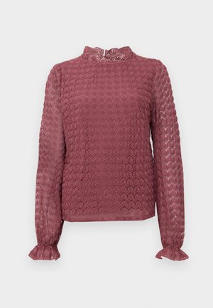 Langermet mauve bluse i blonder med høy hals og volanger på ermene, med et geometrisk blomsterdesign.