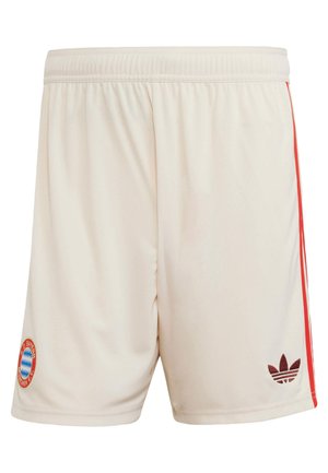 Light beige athletic shorts with an elastic waistband, red side stripes, and a maroon logo patch featuring a three-leaf design.