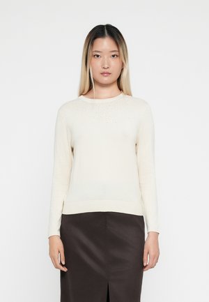 Cream-colored long-sleeve sweater with a ribbed hem and subtle bead accents along the neckline, made of lightweight knit material.
