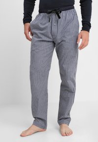 Pantalons de pyjama à carreaux pour hommes en bleu marine et blanc, avec une coupe décontractée, une taille élastique avec cordon de serrage et des poches latérales.