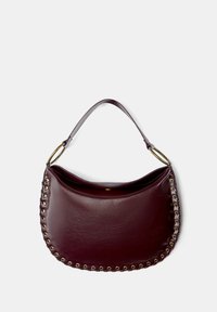 Burgundy leather handbag with a curved shape, featuring a decorative gold-tone grommet trim, sleek handle, and open top design.