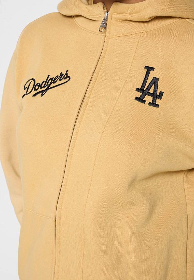 Żółta bluza z kapturem na zamek z wyszywanymi czarnymi logotypami "Dodgers" i "LA", o miękkiej fakturze i kieszeniach z przodu.