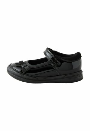 Chaussure Mary Jane en vernis noir avec un bout arrondi, une bride sur le pied et un nœud décoratif sur le devant ; semelle en caoutchouc texturé.