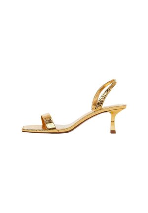 Gold metallic open-toe sandal with a low slim heel and thin straps over toes and around the ankle on a white background.