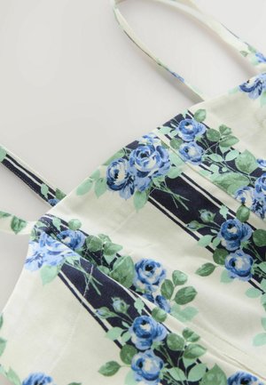 Lille lille lint top, millel on sinised roosid kreemivalgel taustal, õhukeste rihmade ja vertikaalsete mustade triipudega. Tekstuuriga kangas, millel on sile viimistlus.