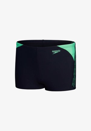Pantaloni da nuoto neri con un accento verde sulla vita e sul lato. Realizzati in materiale elasticizzato, presentano una consistenza liscia e il logo Speedo.