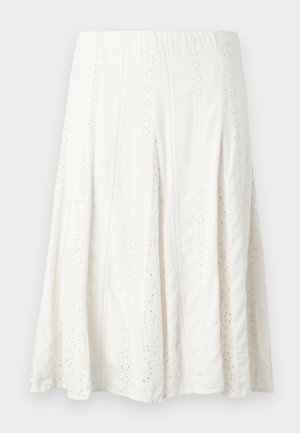 Balta midi garuma svārki ar vertikālām caurumu mežģīņu panelēm un izplūdušu apakšmalu.