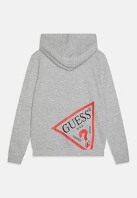 Gray hoodie featuring a large red and black triangular logo on the back, with “GUESS,” “U.S.A.,” and other text details.