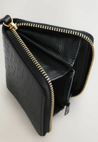 Black leather wallet with a textured surface, gold zipper, and multiple compartments, featuring a sleek rectangular shape.