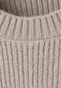 Light gray knitted sweater featuring a ribbed texture and a wide crew neckline, with visible stitching details and a soft finish.