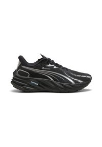 Zwarte sportieve schoen met een getextureerde mesh bovenkant, reflecterende accenten en een dikke, gebogen zool. Beschikt over GORE-TEX en NITRO merknaam.