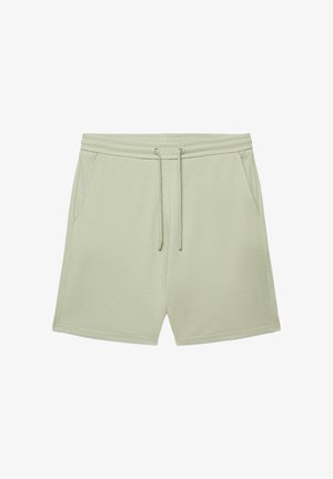 Hellgrüne lässige Shorts mit Kordelzugbund und Seitentaschen aus weichem Stoff, flach auf weißem Hintergrund präsentiert.