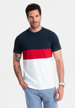 Cotton T-shirt with a navy top, red horizontal stripe, and white bottom. Features short sleeves and a crew neckline. Plain, minimal design.