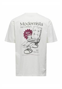 T-shirt en coton blanc avec un graphisme représentant un fauteuil inclinable de style mi-siècle, avec le texte "Modernista" et "Relax in Style" en impression violette et grise.